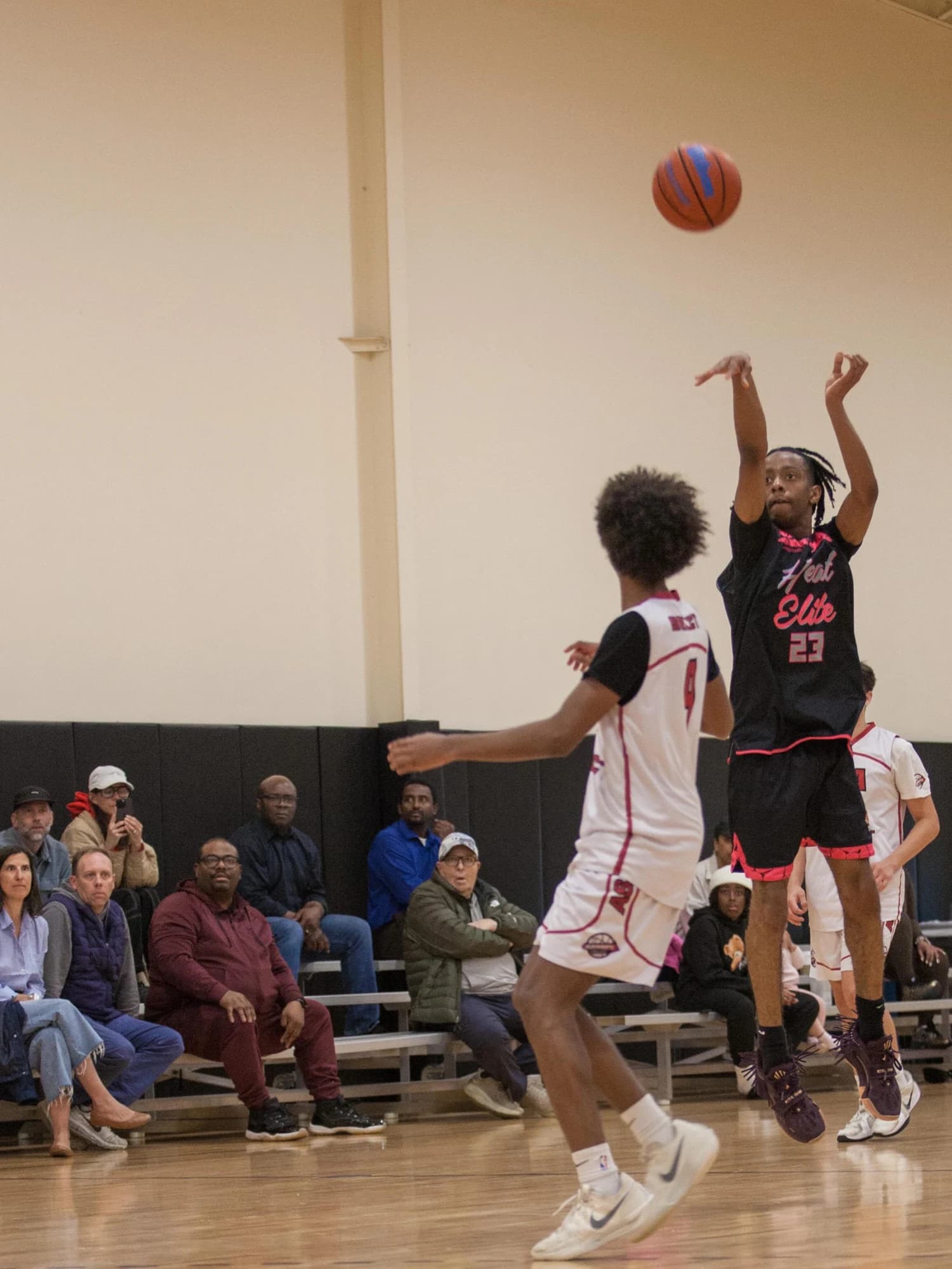 Jacob Mariner rising for a jump shot over a defender in his Heat Elite uniform